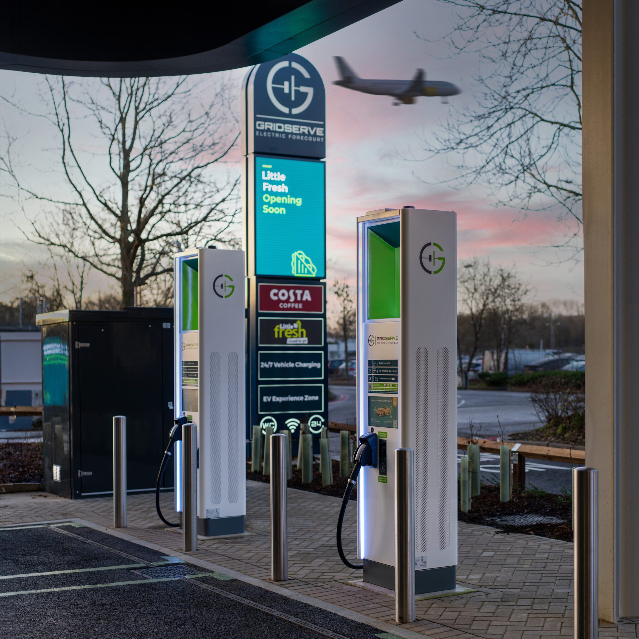 Gridserve charge points at Gatwick with plane in background