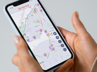 Someone holding a phone, which is displaying the Zapmap app
