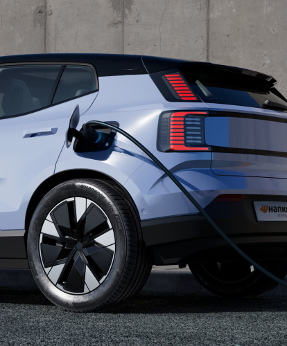 Electric vehicle plugged in to charging device, fitted with Hankook tyres