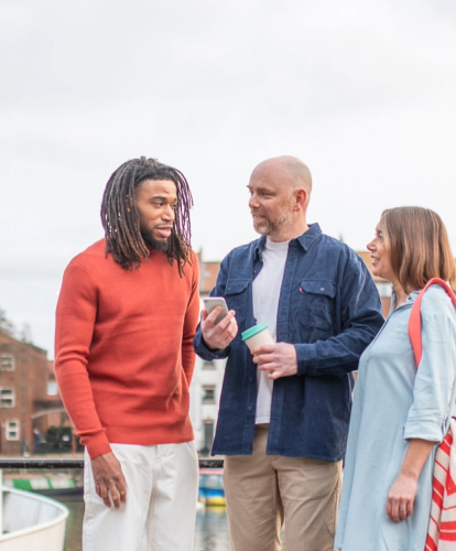 Stock photo - 3 people looking at free charge points on the Zapmap app 