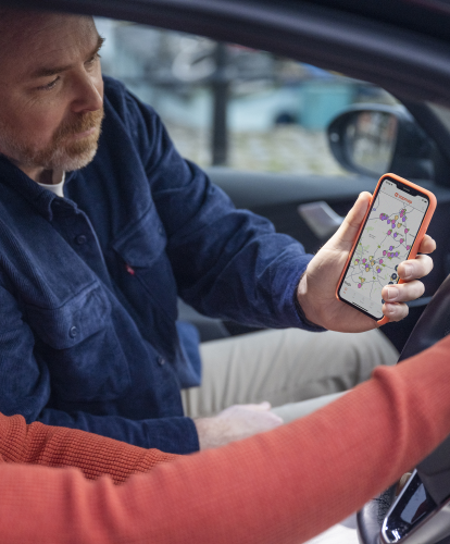 Zapmap appp on phone screen - route planning inside EV
