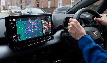 Someone driving with Zapmap's in-car app on the dashboard screen 
