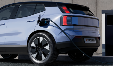 Electric vehicle plugged in to charging device, fitted with Hankook tyres