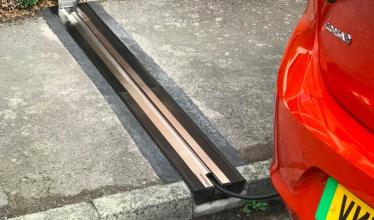 Cross pavement charging solution - gully