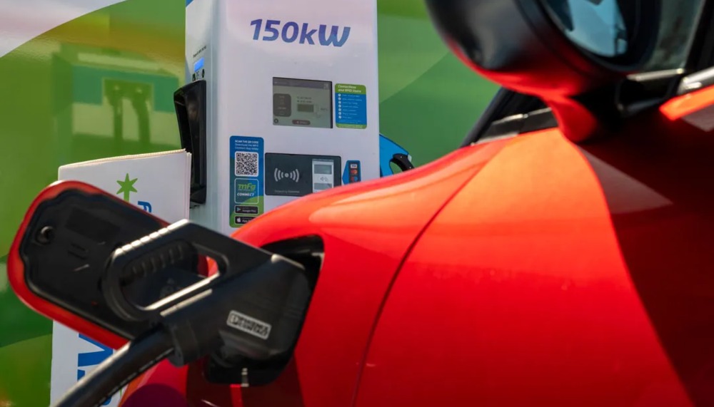 Orange Funky Cat close up of charger port with MFG EV charge point in background